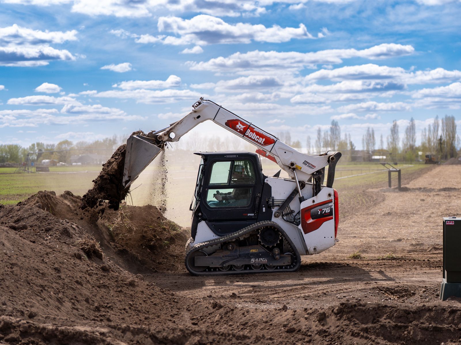 A tracked loader moving dirt on the site